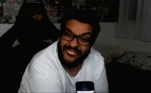 a man with a beard wearing glasses and headphones