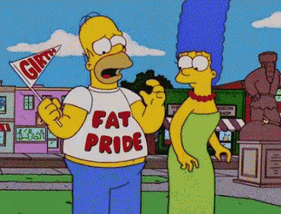 homer simpson is wearing a fat pride shirt and holding a flag