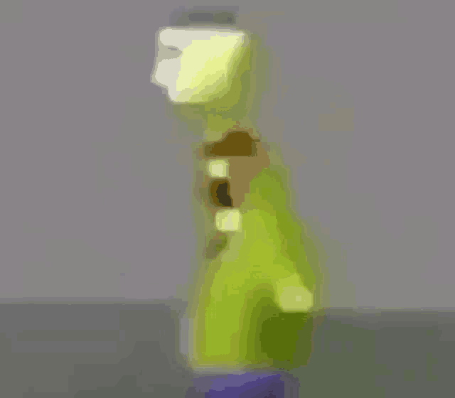 a blurry picture of a cartoon character standing on a purple object .
