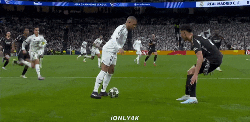 a soccer player with the number 8 on his jersey kicks a ball