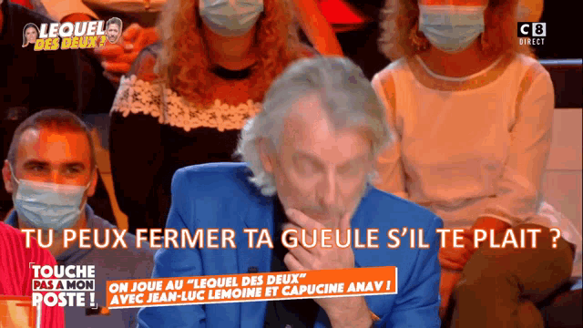 a group of people wearing face masks are sitting in front of a screen that says " touche pas a mon poste "