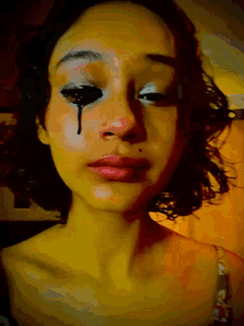 a woman with a black eye and a tear coming out of it