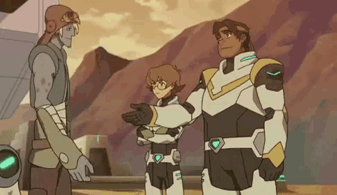 a group of cartoon characters are standing next to each other in front of mountains .