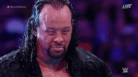 a man with long hair and a beard is on a wrestling show