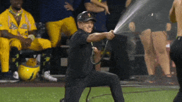 a man kneeling down with a hose in his hand with the letter p on it