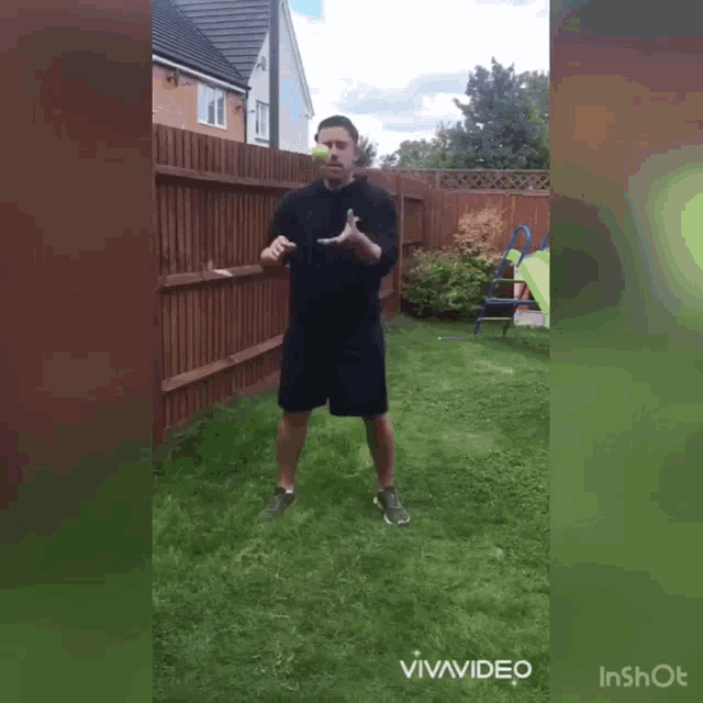 a man in a black shirt and shorts is holding a tennis ball in his hands