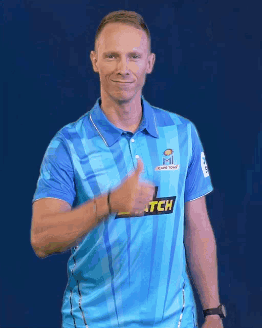 a man wearing a blue shirt that says cape town on it