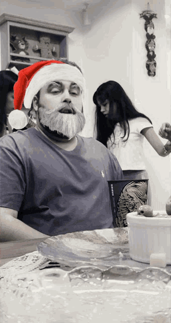 a man with a santa hat on has a beard