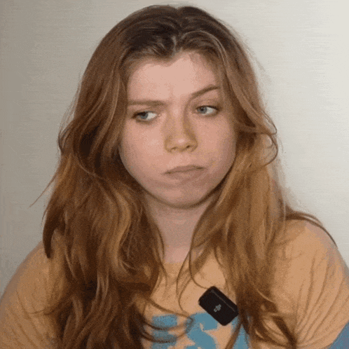 a girl with red hair is wearing a t-shirt that says ' abercrombie & fitch ' on it