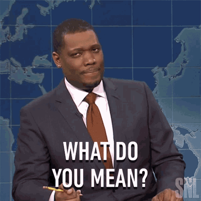 a man in a suit and tie is asking the question what do you mean