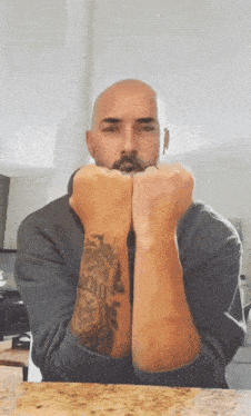 a man with a tattoo on his wrist that says ' brooklyn '