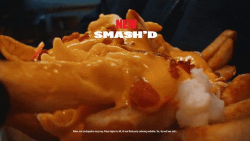a close up of french fries with cheese and bacon with the words " new smash 'd " above it