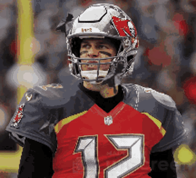 a football player wearing a helmet and jersey with the number 12