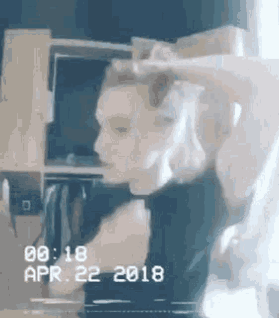 a person is standing in a room with their head in the air .