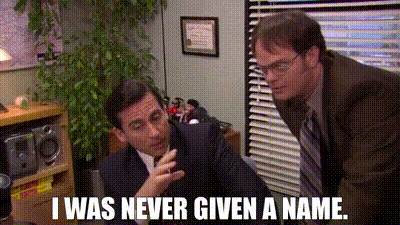 a man in a suit and tie is talking to another man in a room .