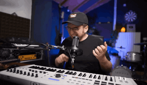 a man is singing into a microphone while playing a keyboard that says korg on it