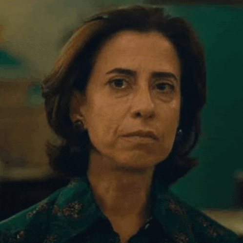 a close up of a woman 's face with a serious expression .