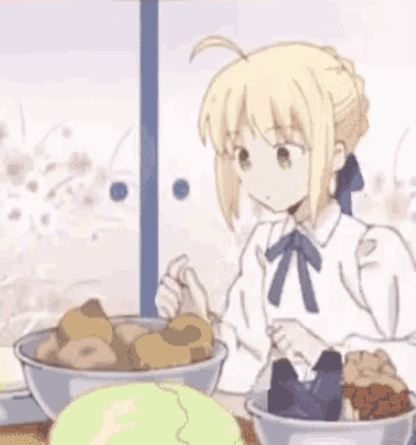 a girl is sitting at a table holding a piece of bread in her hand .
