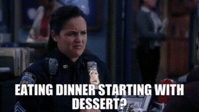 a woman in a police uniform is eating dinner starting with dessert ?