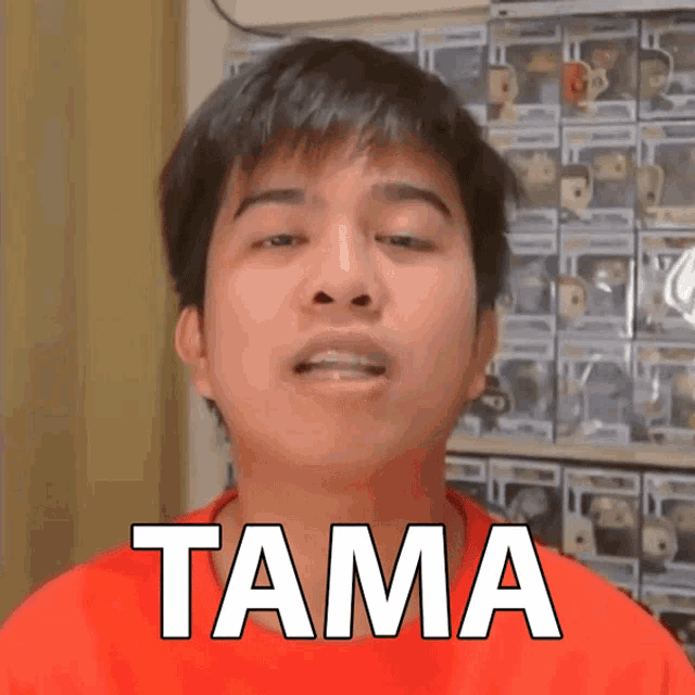 a young man in a red shirt with the word tama on his face