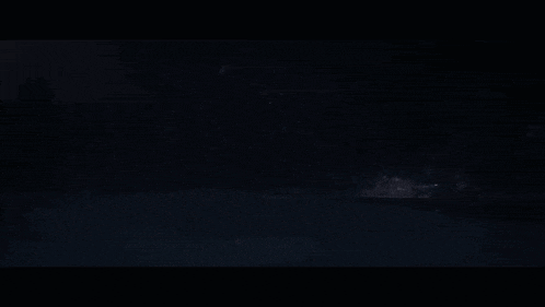 a light is shining through a dark blue background .
