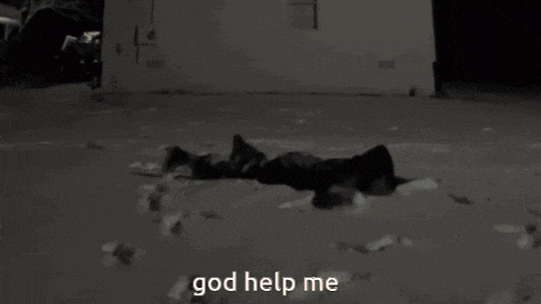 a black and white photo of a person laying in the snow with the words god help me