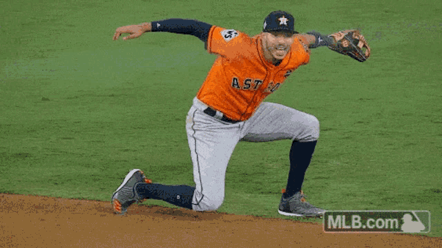 a baseball player for the astros is kneeling down on the field
