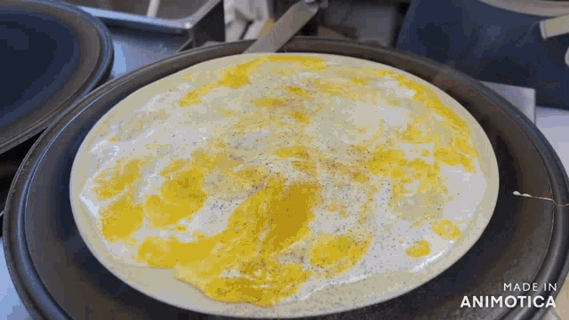 a close up of a pancake on a pan with the words made in animotica below it