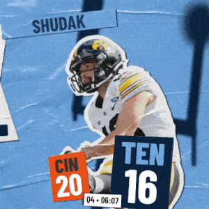 a football player is holding a sign that says " ten 16 "
