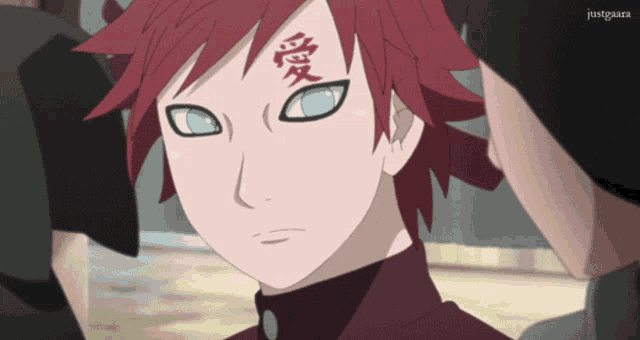 a close up of a cartoon character with chinese writing on his forehead