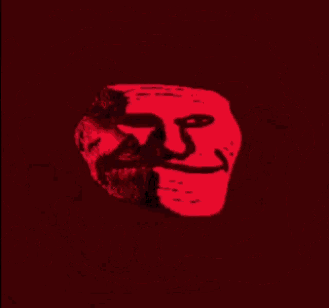 a troll face with a big smile on it is glowing in red light .
