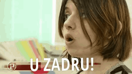a woman with a surprised look on her face and the words u zadru written on the bottom of her face .