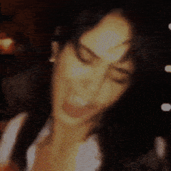 a blurry picture of a person 's face with a yellow and orange background
