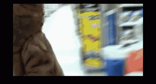 a blurry picture of a person in a store aisle