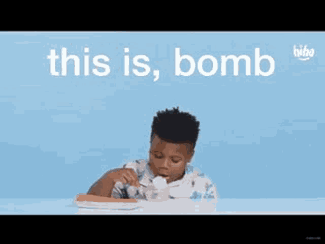 a young boy is sitting at a table eating food with a fork .