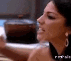 a close up of a woman 's face with the name nathalie on the bottom right corner .