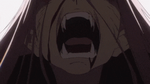 a close up of a person 's mouth with fangs