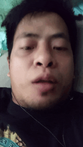 a close up of a man 's face with a shirt that says eee on it