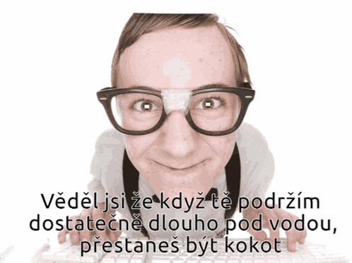 a man wearing glasses and a bandage on his nose is typing on a computer keyboard