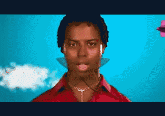 a pixelated image of a man wearing a red shirt and a necklace with the letter t on it