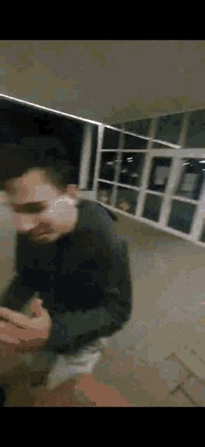 a blurry picture of a man wearing sunglasses and a black sweater