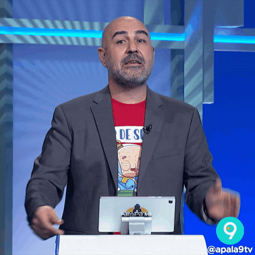 a man in a suit is standing in front of a screen that says at & t on it