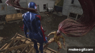 a man in a blue suit is standing next to a monster with long red hair and the words make a gif.com below him