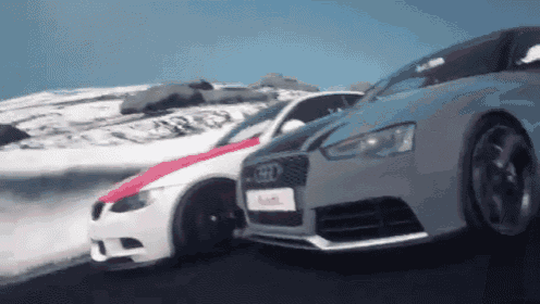 a bmw and a audi are driving down a snowy road