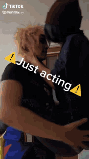 a man is holding another man in his arms and says just acting