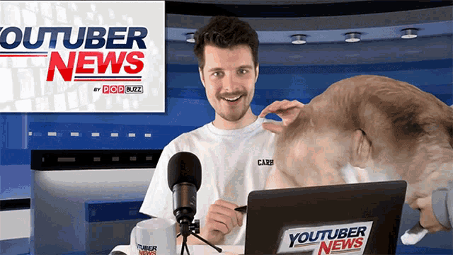a man is sitting in front of a laptop with a youtuber news sticker on it