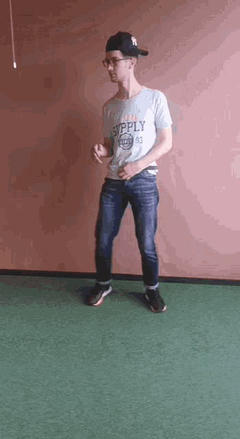 a man wearing a shirt that says supply is dancing