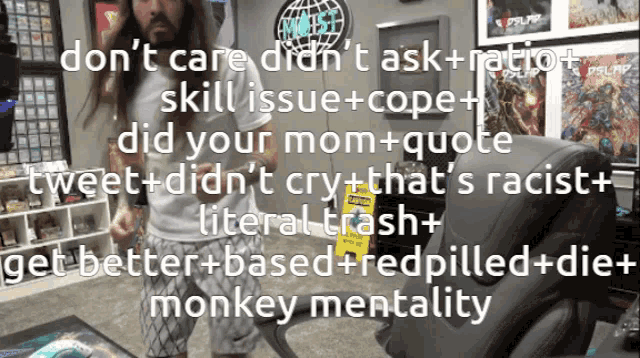 a man with long hair stands in front of a sign that says ' monkey mentality ' on it