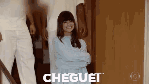 a woman in a straitjacket is standing in front of a group of people with the word cheguet written on the bottom