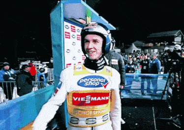 a man wearing a vest that says personal shop viesmann
